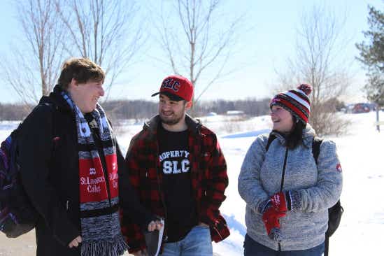 three students outside on campus